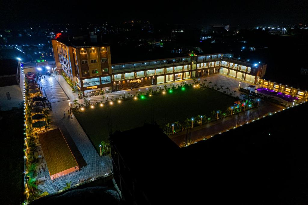 a large building with lights in front of it at night at THE BODHI PALACE RESORT in Bodh Gaya