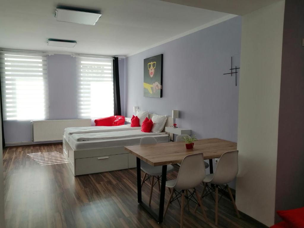 a bedroom with a bed and a table and chairs at Violet House in Turda