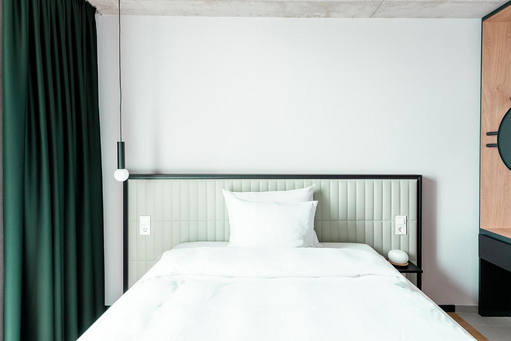 Postel nebo postele na pokoji v ubytování Coreum Hotel