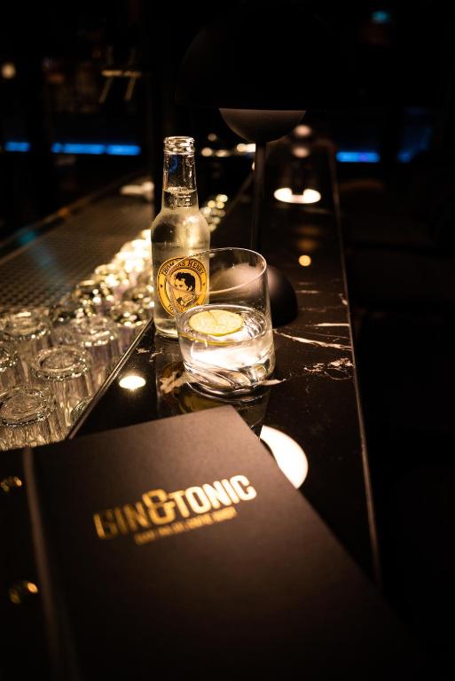 a table with a bottle of alcohol and a glass at Hotel Atlantic Juist in Juist