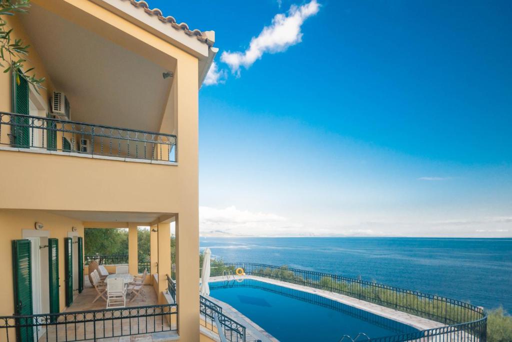 a view of the ocean from the balcony of a house at Villa Spyros in Nisaki