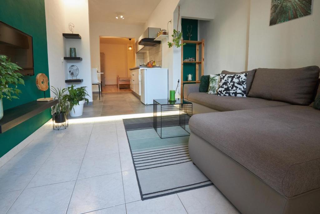 a living room with a couch and a kitchen at Apartment Green in Poreč