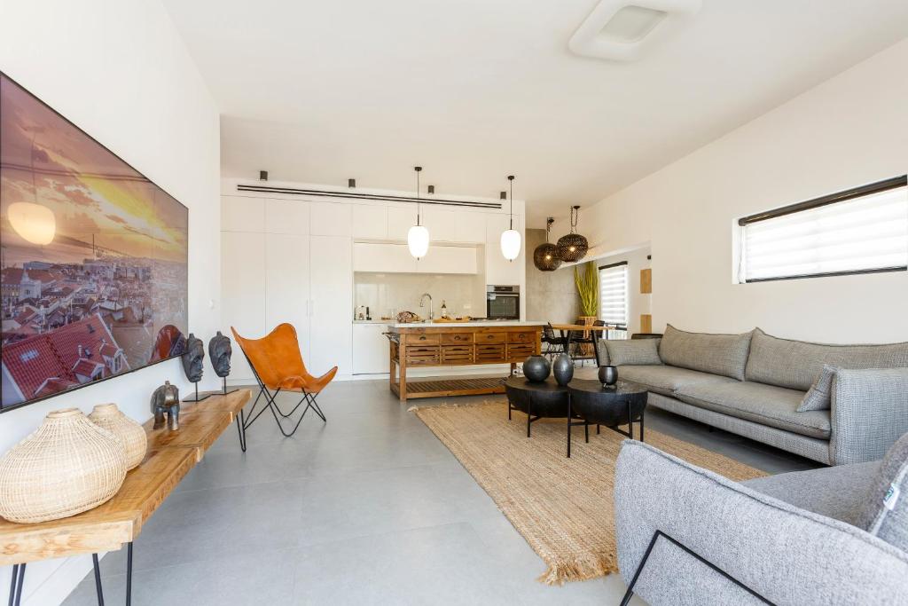 a living room with a couch and a table at AirTLV - Bazel Central Apartment With Balcony in Tel Aviv