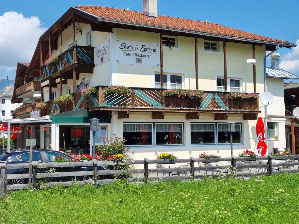 a large building with flowers in front of it at Wohlfühl-Appartement Bergsee FAMILY - am Wildsee - SUP und Schlitten for free in Seefeld in Tirol