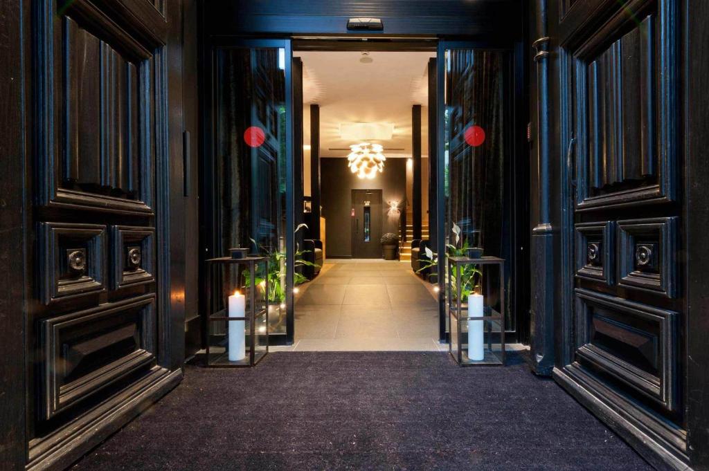 a hallway of a building with two doors and candles at Hotel Paseo de Gracia in Barcelona