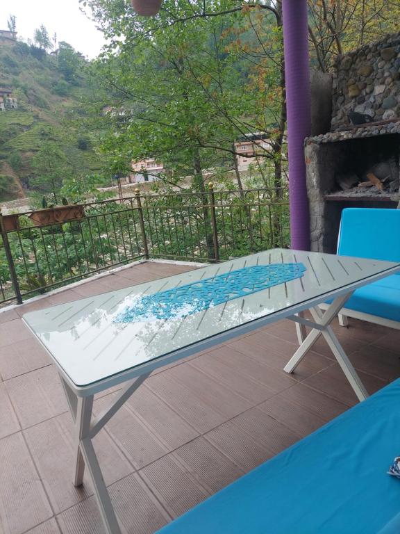 a glass table on a patio with a view at Hânetül Mabeyn in Rize