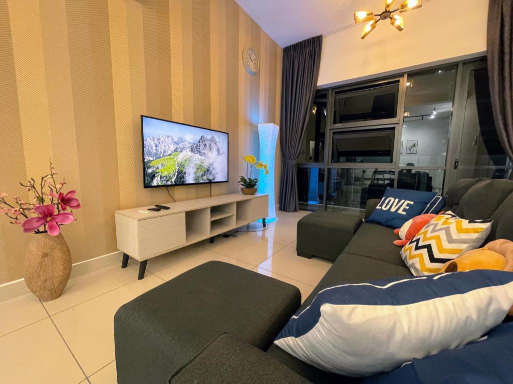 a living room with a couch and a flat screen tv at Pacific Tower Petaling Jaya Near Jaya One, University Malaya, Columbia Hospital By My Homez in Petaling Jaya
