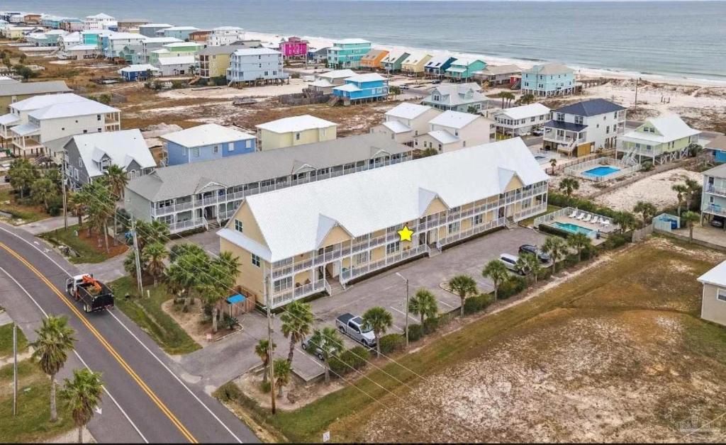 an aerial view of a resort next to the ocean at GulfShores BeachCondo - Pool - FreeParking - SummerTime! - Little Lagoon in Gulf Shores