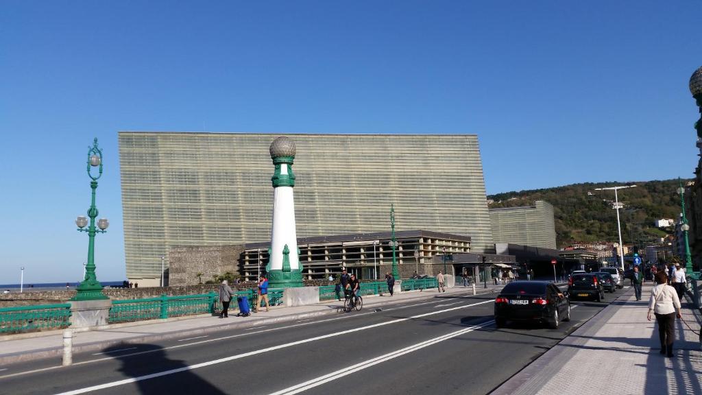 a building with a lighthouse in the middle of a street at Hotel Parma in San Sebastián