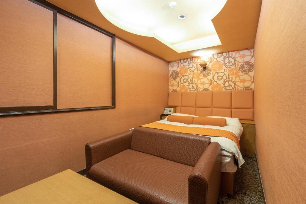Postel nebo postele na pokoji v ubytování ホテル ロコガーデン 三重菰野