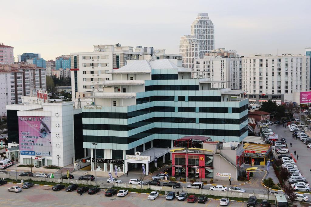 a large building with cars parked in a parking lot at Sarissa Hotel in Istanbul