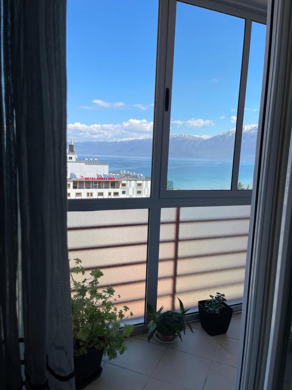 a view of a cruise ship from a window at City Center With Lake View One Bedroom Apartment in Pogradec