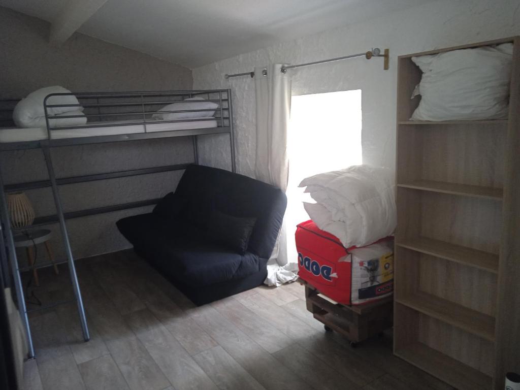 a small room with a bunk bed and a chair at les figuiers et les rosiers proche puy du fou in Saint-Germain-de-Prinçay