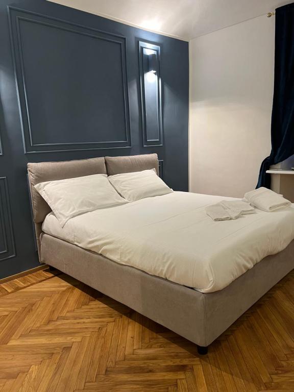 a bedroom with a large bed with white sheets at Turin Central Suite in Turin