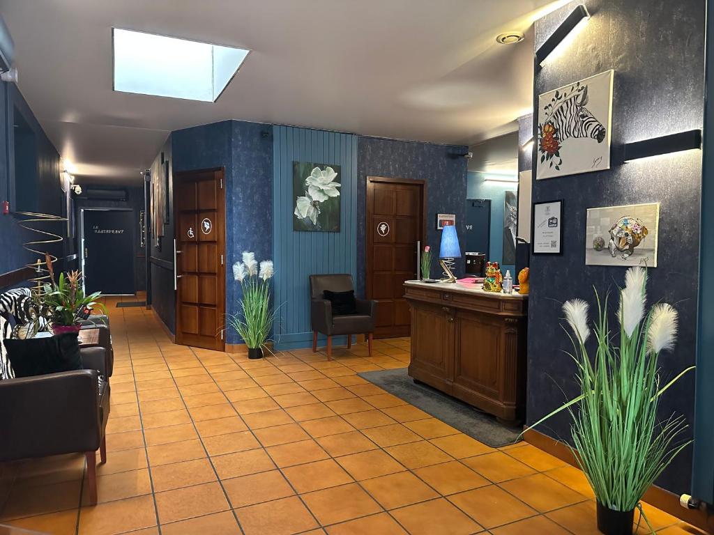 a lobby with a waiting room with a reception desk at L'EMBLEME - BOUTIQUE HOTEL in Beaurepaire