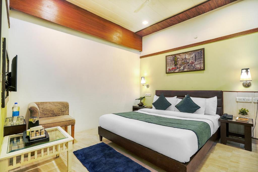 a hotel room with a bed and a chair at Hotel Seven- Center of City Chandigarh in Chandīgarh