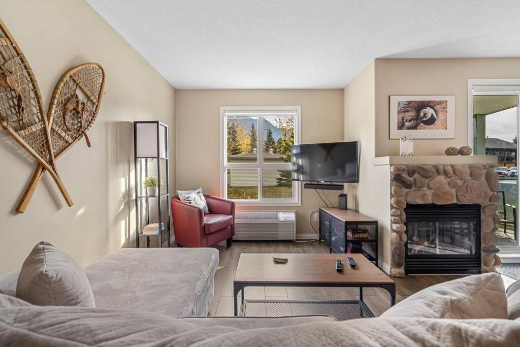 a living room with a couch and a fireplace at Polar Peaks Hot Tub Pool Gas Fireplace in Radium Hot Springs