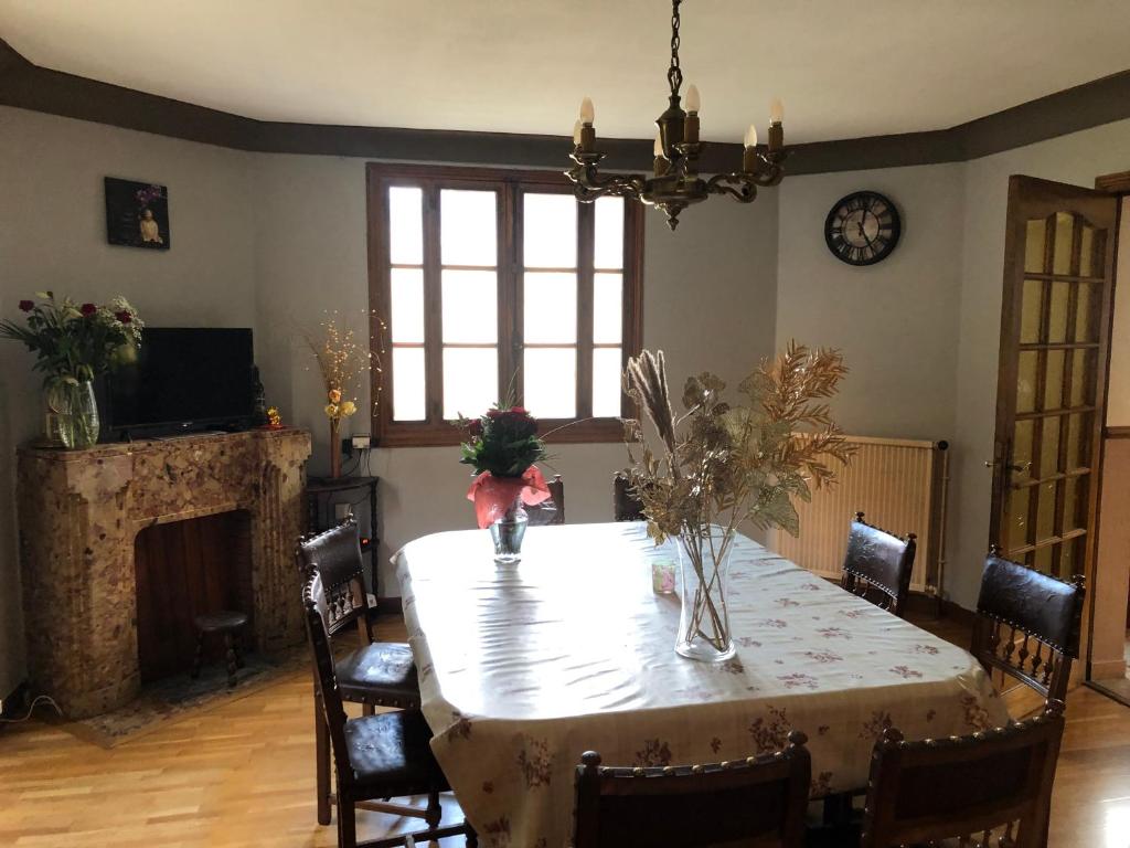 a dining room with a table and a fireplace at Maison à sainte marie de Campan in Sainte-Marie-de-Campan