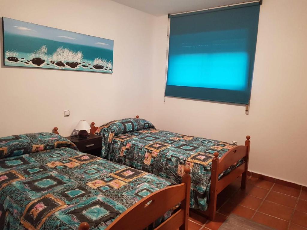 Postel nebo postele na pokoji v ubytování CHALET EN PLAYA ROBAYERA