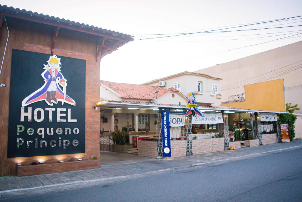 a hotel sign on the side of a street at Hotel Pequeno Principe in Arapiraca