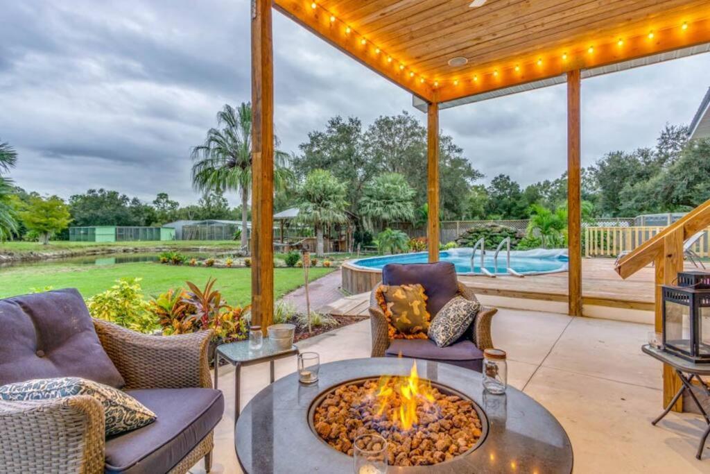 a patio with a fire pit and a pool at Tropical getaway Pool and tiki bar in Cleveland