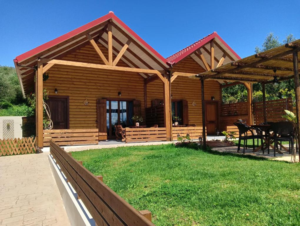 a log cabin with a table and a patio at Chalet edelweiss preveza in Preveza