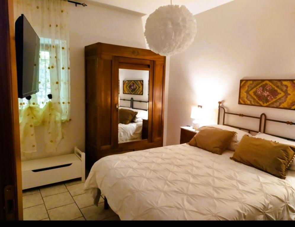 a bedroom with a large bed and a mirror at Mameli Suite in Spoleto