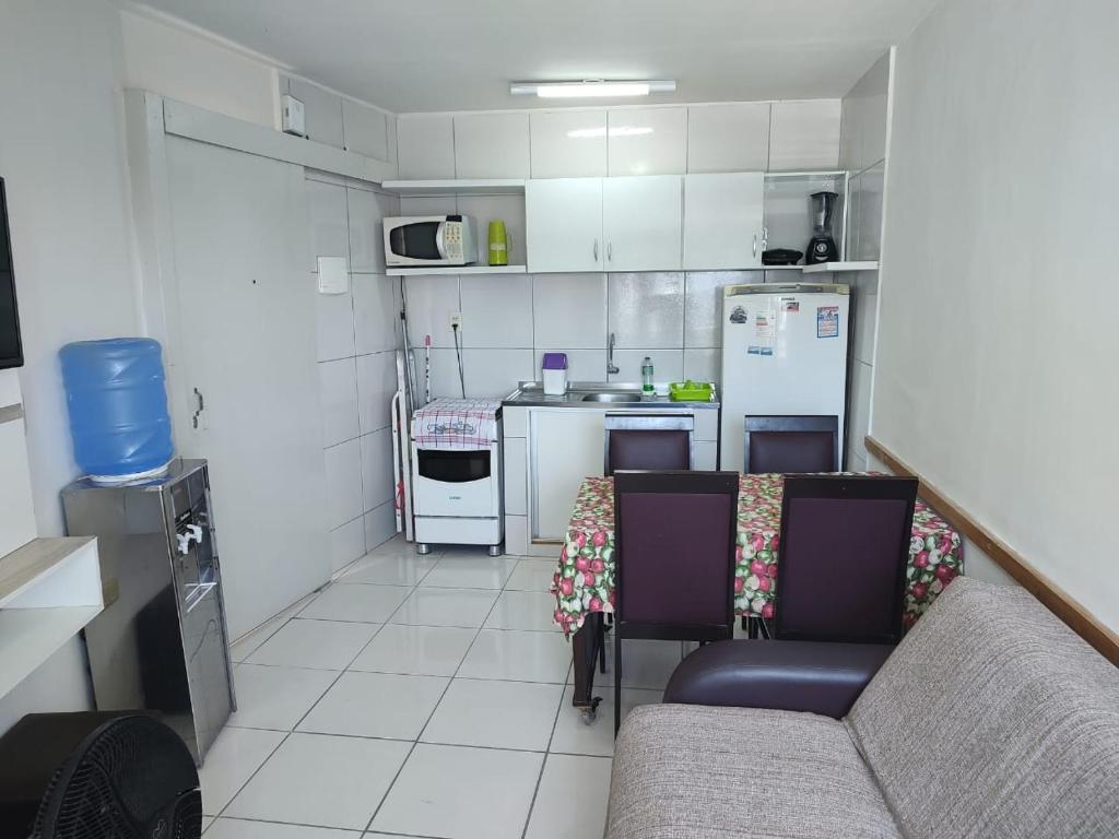 a small kitchen with a couch and a refrigerator at Boa Vista in Recife