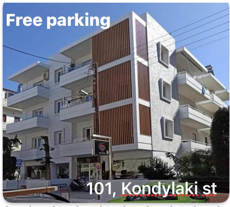 a large white building with a sign in front of it at Kondylaki Apartments in Heraklio