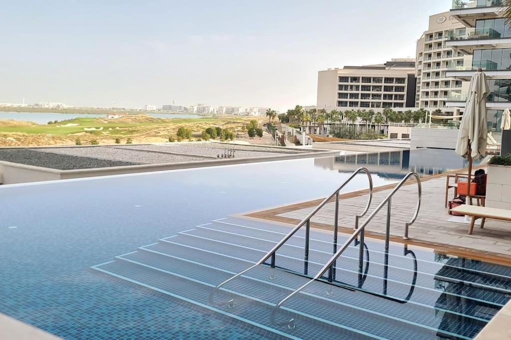 a swimming pool with blue water in a building at Luxury apartment in Yas Island in Abu Dhabi