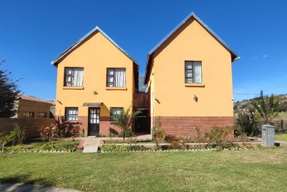 a large yellow house with a yard at 22 on Titanic in Clarens