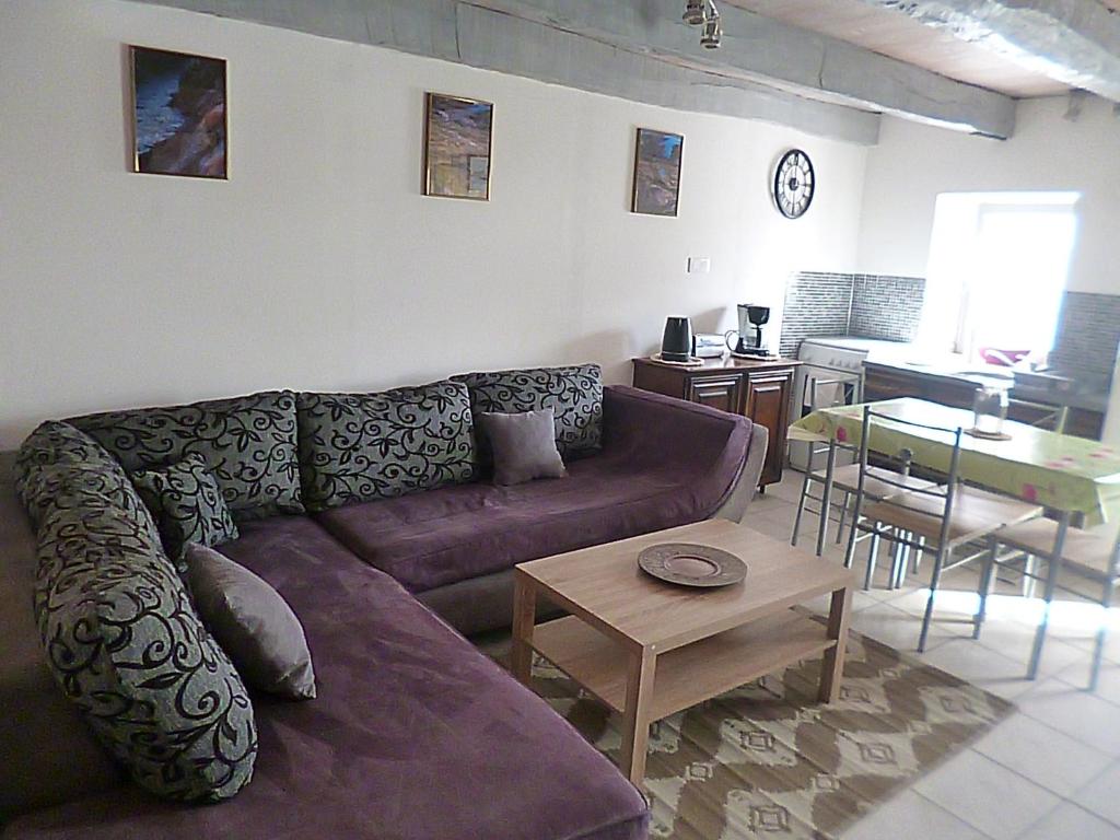 a living room with a couch and a table at gite du guip in Trégourez