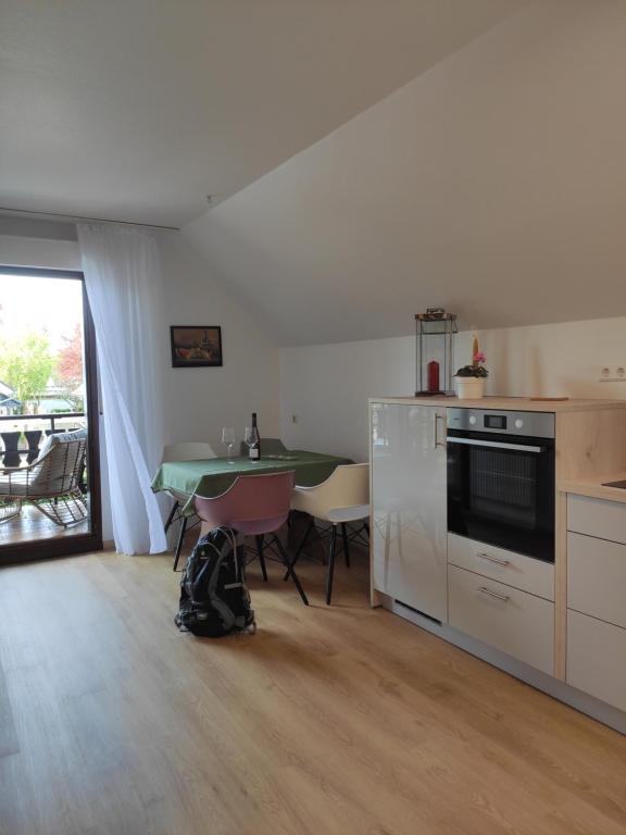 a kitchen with a table and a dining room at Ferienwohnung Unter dem Sonnberg in Auggen