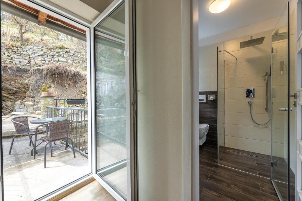 a glass door leading to a bathroom with a shower at Apartmány U Pavla in Český Krumlov