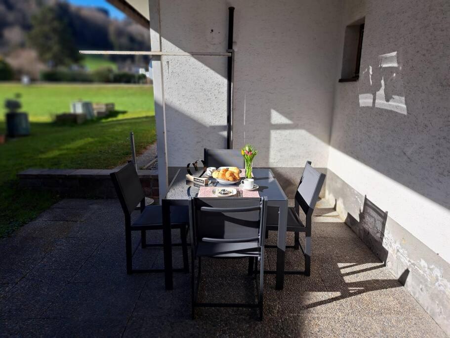 uma mesa com cadeiras e uma tigela de fruta em Ferienwohnung Zanier em Gaißau