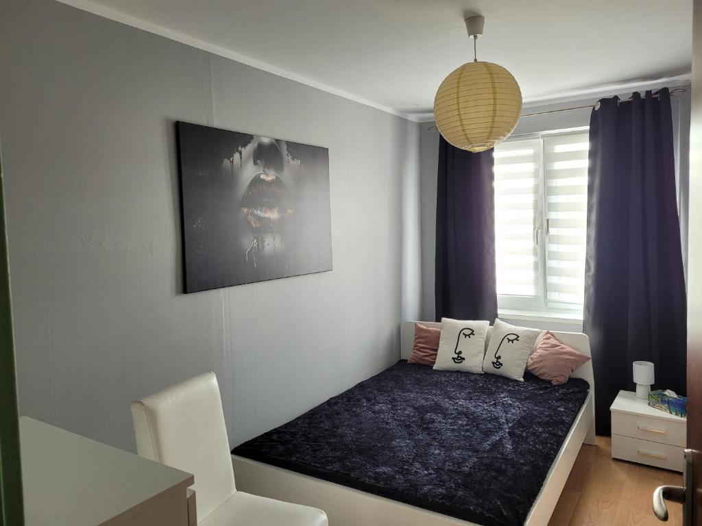Posteľ alebo postele v izbe v ubytovaní Apartament Palisadowa