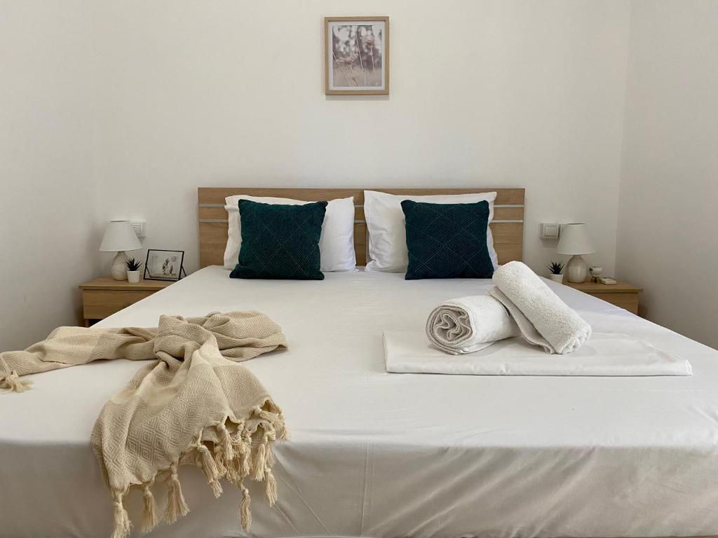 a large white bed with two pillows on it at Elgreco Apartment, near the sea, in Kos town "14" in Kos