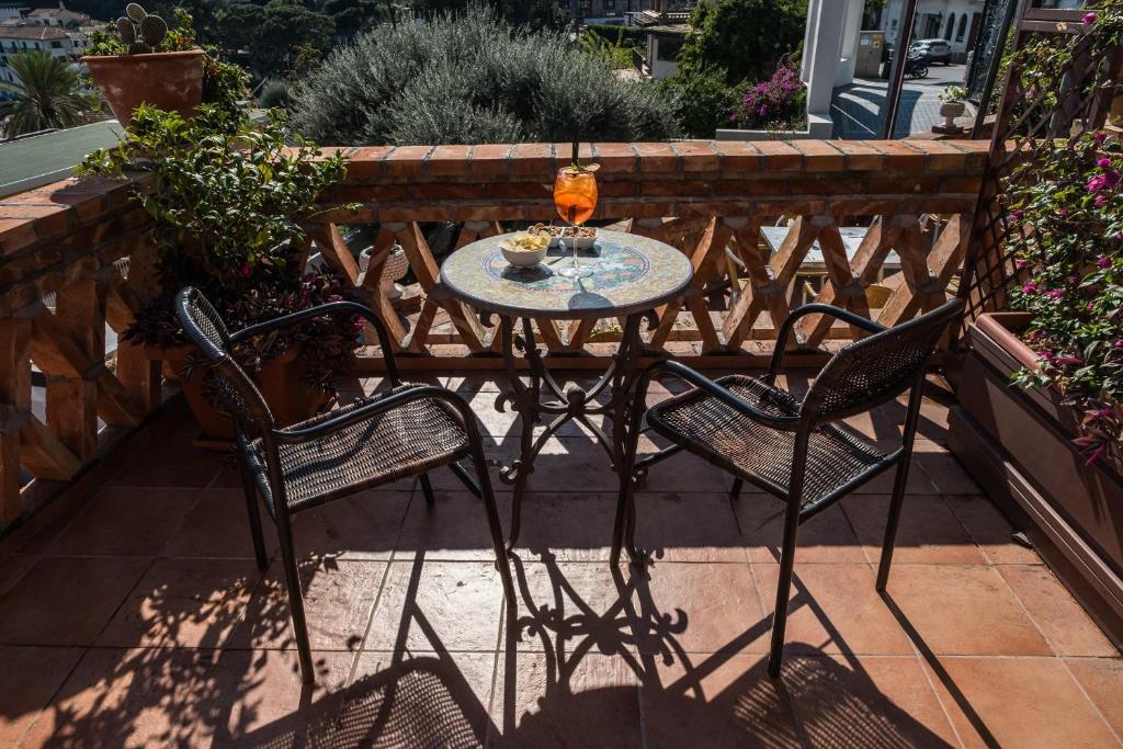 a table and two chairs on a patio at Hotel Villino Gallodoro in Taormina