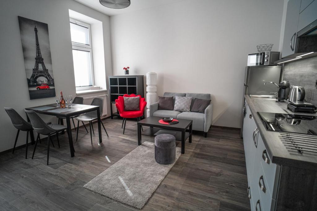 a kitchen and living room with a couch and a table at Apartmánový dům Sklípek in Trutnov