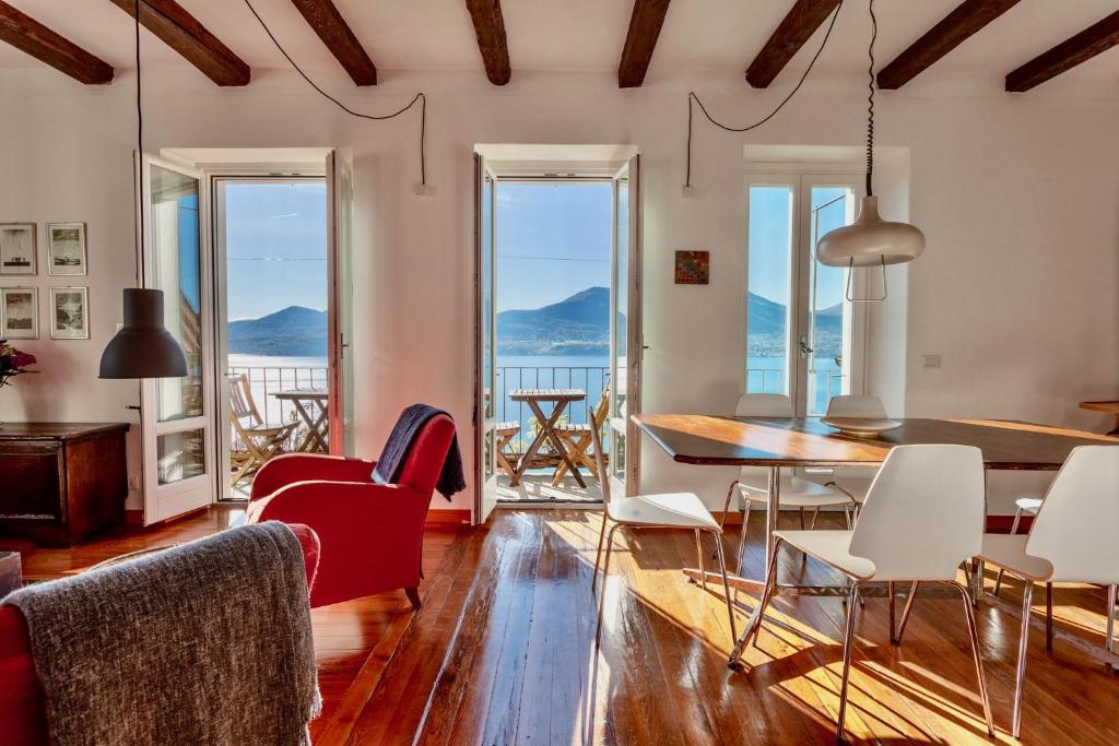 a living room with a table and chairs and views of the ocean at Cadebei in Oggebbio
