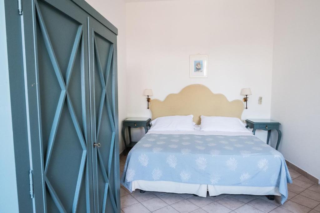 a bedroom with a large bed and a large door at Hotel Villino Gallodoro in Taormina