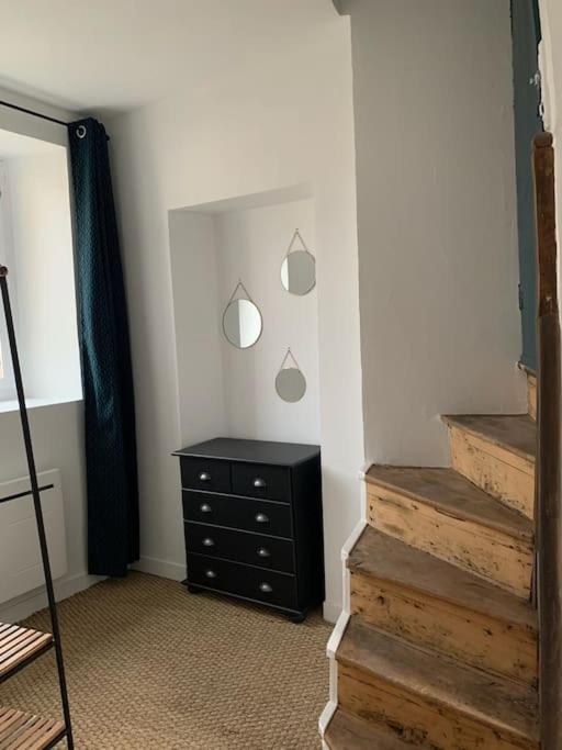 a room with a dresser and a mirror and stairs at Maison Angouleme, France in Angoulême