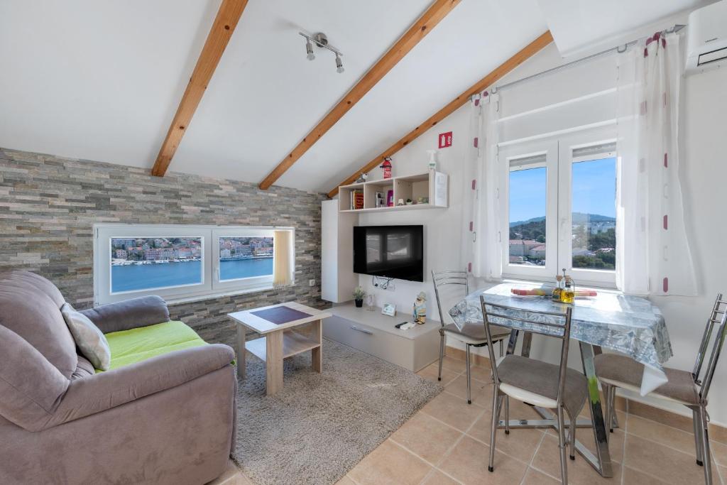 a living room with a couch and a table at Apartments Joni Čikat in Mali Lošinj