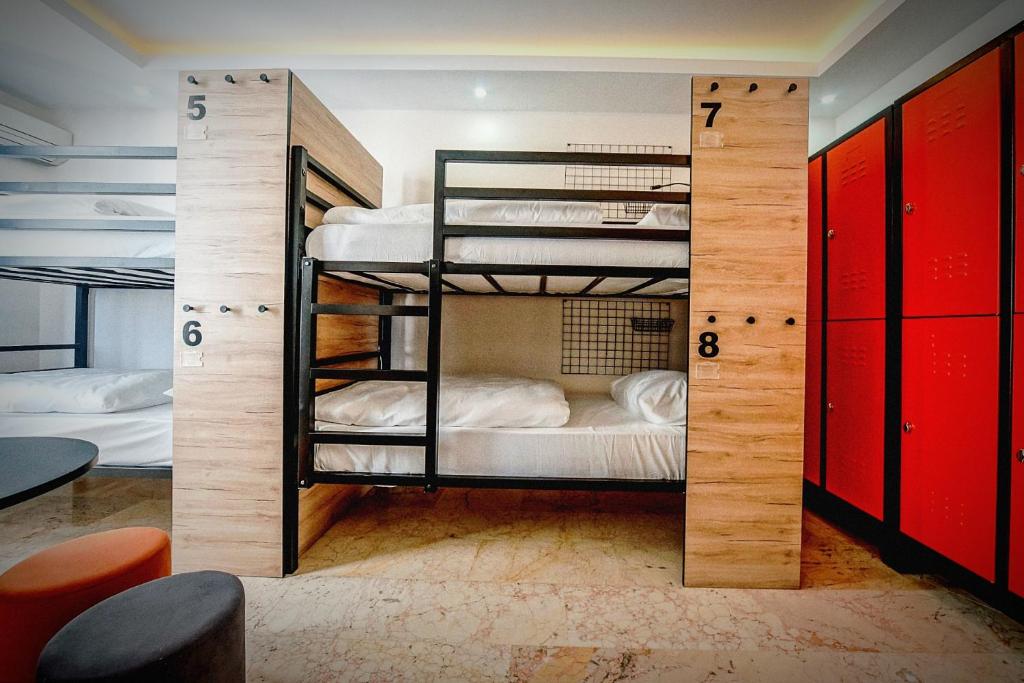 a room with two bunk beds with red cabinets at Manu Startup House in Istanbul