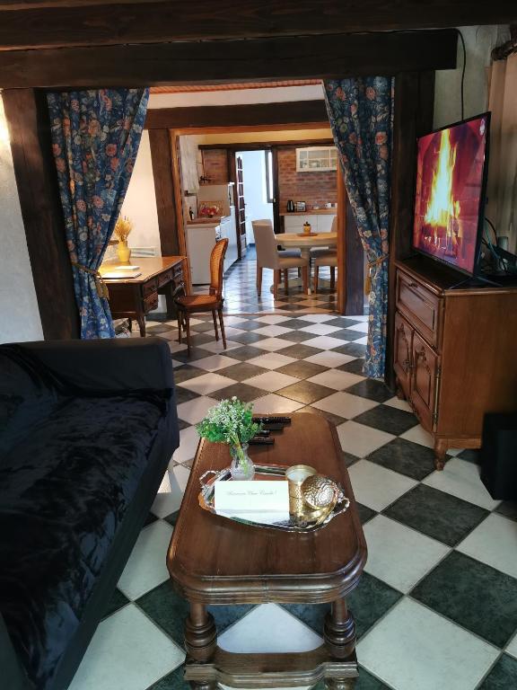 a living room with a couch and a table at Le gîte du Brouage in Chauny