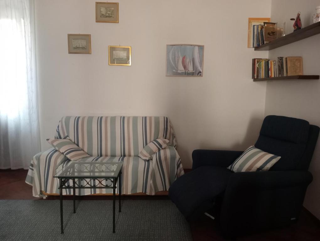 a living room with a couch and a chair at Casa Azzurra in Orbetello