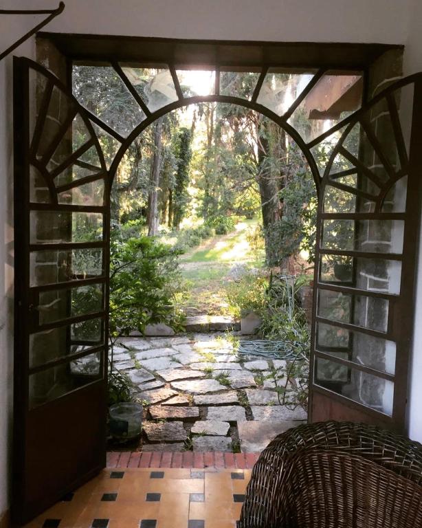 an open door leading to a stone walkway at La Escondida de la Aldea Serrana in Valle Hermoso