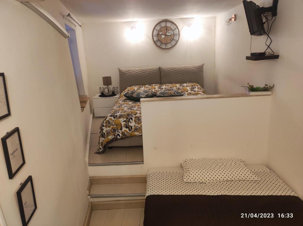 a small room with a bed and a staircase at Montesanto House Palermo in Palermo