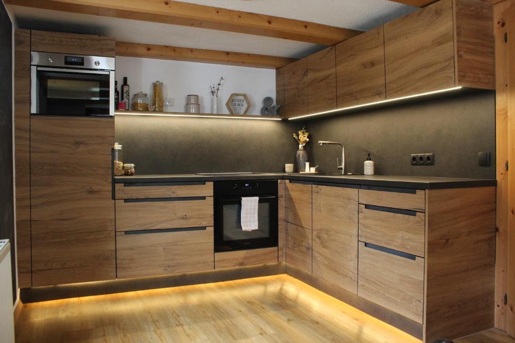 a kitchen with wooden cabinets and a sink at Haus Eder in Ginzling