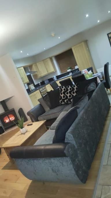 a living room with a couch and a table at Meadow View in Moneymore
